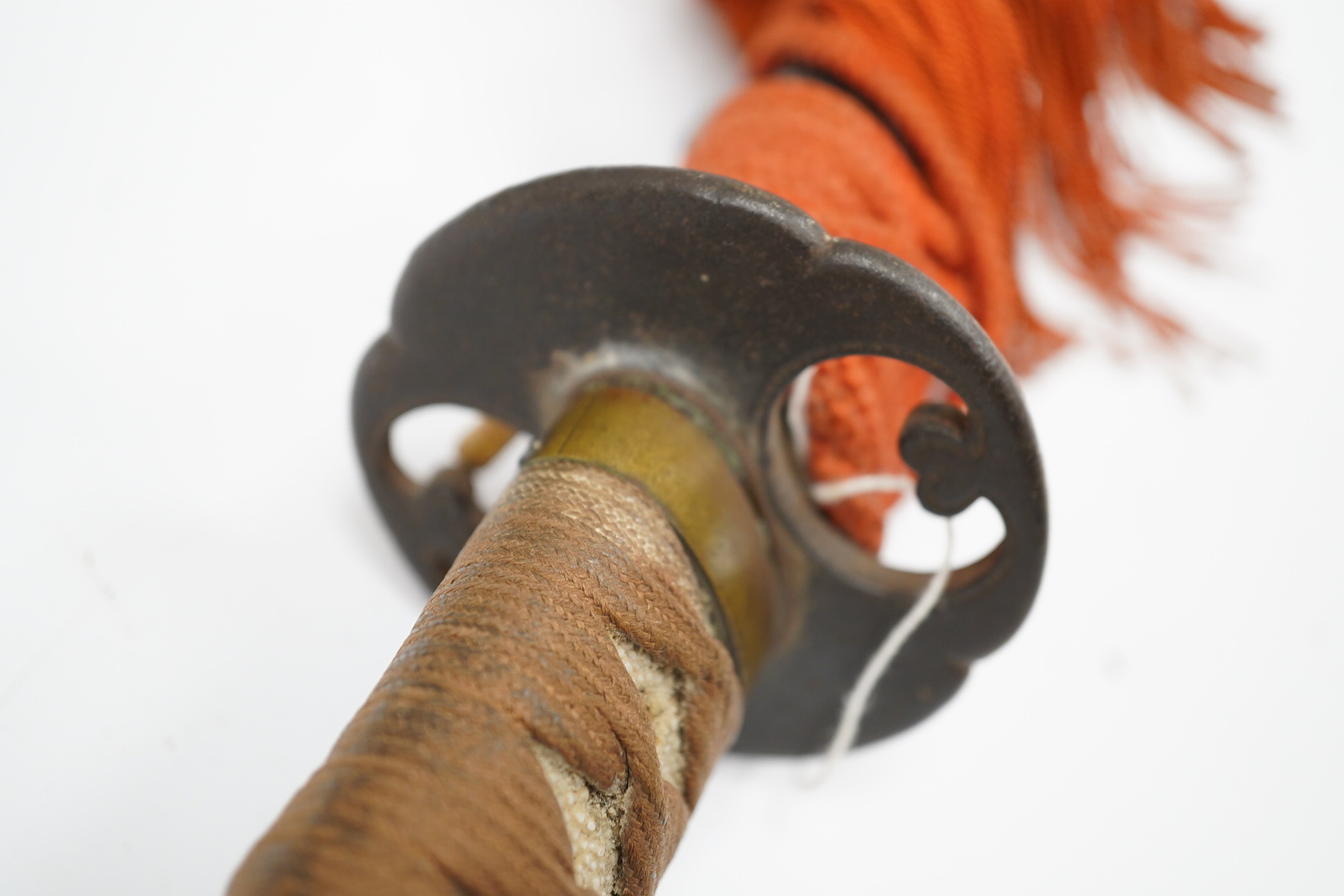 A 19th century Japanese sword wakizashi, blade 39.9cms, signed, iron Sukashi Tsuba of moko form, tape bound same tsuka with brass mounts, in its black lacquered saya. Condition - fair